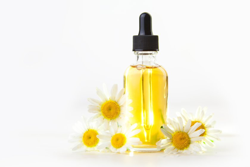 Essence of flowers on a table in a beautiful glass jar