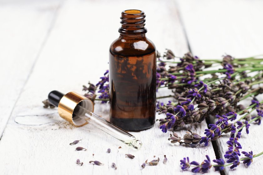 Still life, health and beauty, spa concept. Dry lavender and oil  on a white wooden table. Selective focus